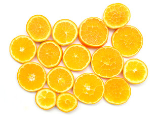 Orange citrus slices on white background closeup.Top view. Vibrant abstract pattern of juicy pieces, which bright circles look like small suns. Fresh healthy food, tasty fruit from Greek garden.