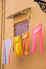 Bright clothes drying on the clothesline in the historic city center