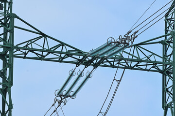 Disk insulators and cables on the top of the pylon for high voltage electrical transmission line