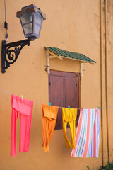 Colorful clothes drying on the clothline on historic old house