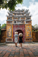 Backpacker couple enjoy trip through southeast Asia in imperial city of Hue, Vietnam