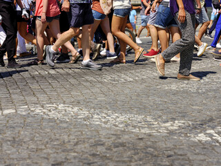 Many people walking in the city center of Porto. Pedestrians crossing the busy street on the pedestrian crossing in the city center of Porto, Portugal