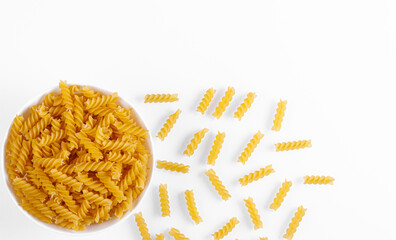 Pasta products in the form of a spiral on a plate, texture, on a white background