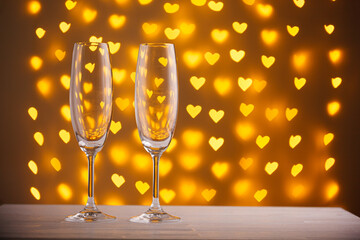 beautiful glasses of champagne on a blurred background of hearts