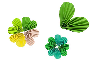 Paper accordion hearts and clover in green, yellow and beige colors on a transparent background. Spring inspiration and decoration for your collage, artwork.