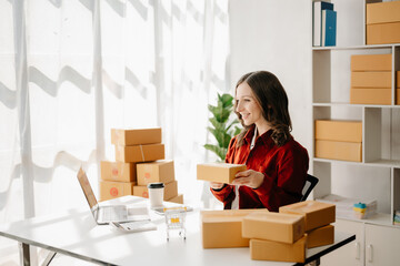 Naklejka na ściany i meble Small business entrepreneur SME freelance woman working at office, BOX,tablet and laptop online, marketing, packaging, delivery, e-commerce concept..