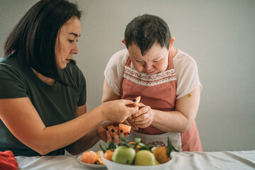 Lifestyle, education. An elderly woman with down syndrome is studying in the kitchen or classroom...