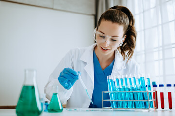 Female biotechnologist testing new chemical substances in laboratory.