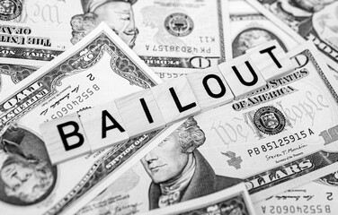bailout inscription next to american dollars. Saving failing banks. Financial crisis concept