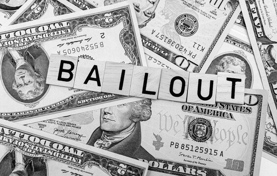 bailout inscription next to american dollars. Saving failing banks. Financial crisis concept