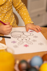 closeup of a child coloring the easter bunny