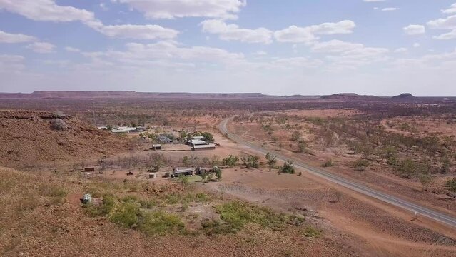 Aerial Shot of a Rest Stop in the Outback alongside Stuart Highway under a Patchy Sky, Australia (UHD)