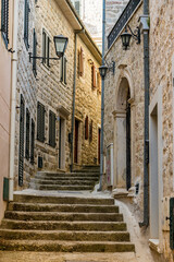 Fototapeta na wymiar Cozy old narrow street with steps in the Old town of Herceg Novi