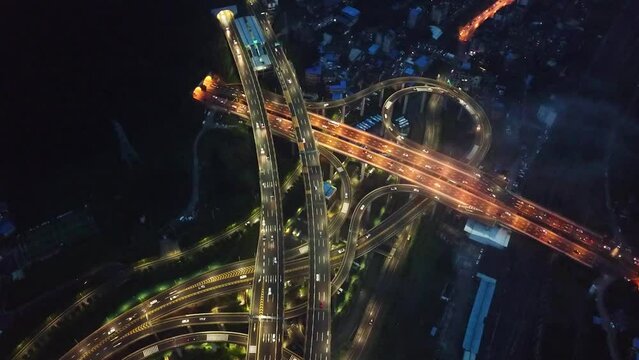 Glowing traffic lights, high up aerial shot of the highway intersection of Chongqing, Huangjuewan, China.