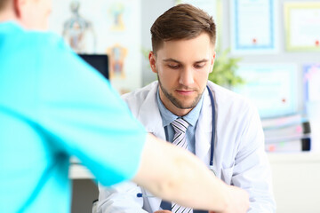 Doctor talks and listens to patient in clinic