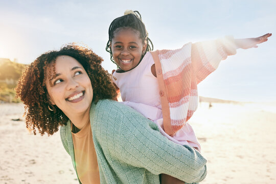 Portrait, fly or girl with mother at beach on summer holiday vacation together as a happy family. Fun African mom, piggyback or excited young child love bonding, relaxing or playing in nature or sea
