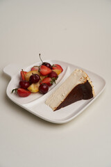 Cheesecake with fresh fruits on white background
