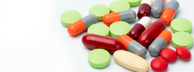 Tablets pills and capsule pills on white background. Drugs, vitamins, minerals, and supplements...