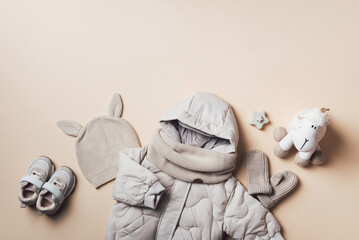 Children's clothing, shoes - hooded puffer jacket, knitted hat, scarf, boots, sheep toy on neutral...