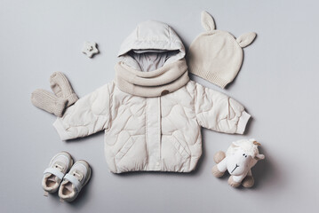 Fashion children's clothing, shoes - hooded puffer jacket, knitted hat, scarf, boots, sheep toy on...