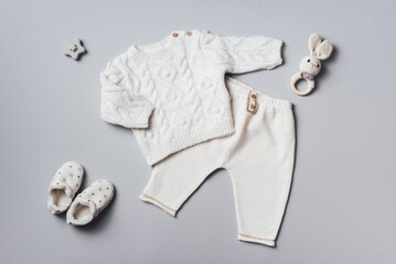 Knitted sweater, pants, shoes, bib and wooden toys. Set of baby stuff and accessories for newborn...