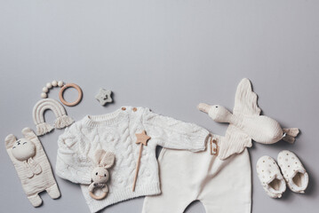 Knitted sweater, pants, shoes, bib, wooden toys and soft bird. Set of baby stuff and accessories...