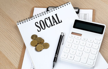 SOCIAL text on a notebook with chart and calculator and coins, business concept