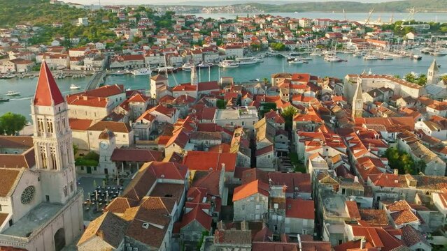 Aerial shot of magnificent Venetian city on the Adriatic Sea - Trogir, Croatia. Morning shot of old town Trogir with orange tiled roofs