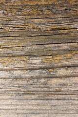 a weathered wooden board with horizontal cracks
