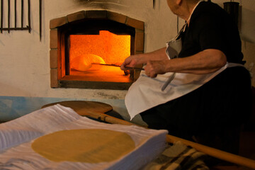 preparation of Sardinian Pane Carasau, Carasau bread, traditional crispy bread of Sardinia, Italy
 - obrazy, fototapety, plakaty