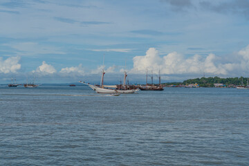 View from the ferry to Waisai at Sorong with cruises and tour boats, background blue sky, copy space