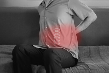 Back pain concept, kidney inflammation, man suffering from backache at home.