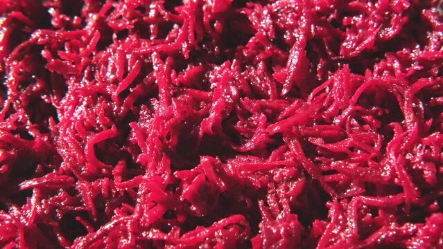 Beetroot salad with dressing and spices. Cooked chopped beet. Asian dish grated beets or beetroot and condiments, garlic, onion and pepper. Food background spinning. Copy space top view Full Frame