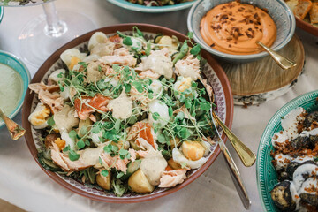 Salad with salmon, eggs and croutons on a table. Healthy food concept. Soft focus.