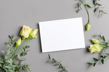 Blank invitation or greeting card mockup with fresh eustoma flowers