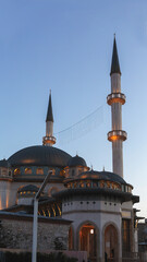 Taksim Mosque (Taksim Camii). Mosque complex at Taksim Square at blue hour with backlight. Istanbul, Turkey (Turkiye). Travel or religion concept. Vertical shot