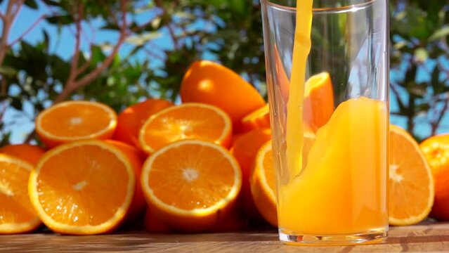  Orange juice swirls into a wave in a glass 