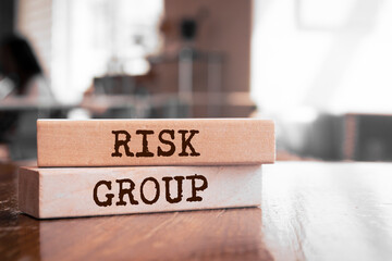 Wooden blocks with words 'RISK GROUP'.