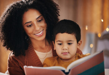 Night, book and mother with child reading for bedtime storytelling, fairytale and education. Relax, happiness and smile with boy listening to woman at home for learning, creative and literature