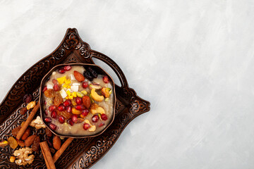 Ashure or Asura Dessert, also called as Anusabur on metal serving tray. Sweet pudding also called...