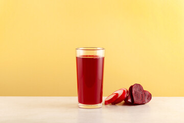 Red Gemuse vegetable drink in tall glass. Vegan Smoothie Juice of radishes, purple carrots, beets,...