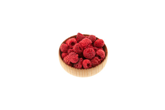 Dried freeze dried raspberries in wooden bowl on white background. Selective focus, copy space. Dehydrated raspberry berries. Clever Storage healthy food