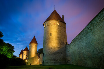 Night view of illuminated defensive city walls of Estonian capital - Tallinn