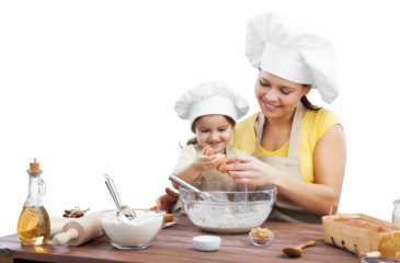 The beautiful young mother and her little daughter cook at home