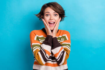 Portrait of excited optimistic lovely woman with short hairdo wear orange sweater palms on...