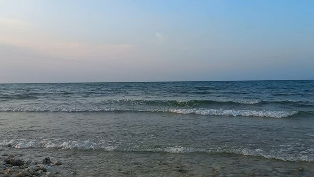 Beautiful white sand seascape sunset beach with calm wave at Tuban, East Java, Indonesia. Tranquil coastline scenery