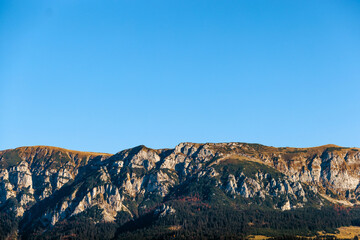 Mountain top on blue sky background on sunny day.