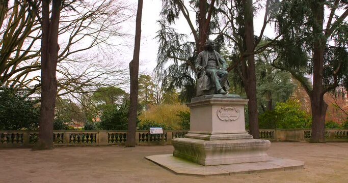 Statue Of Michel Eugène Chevreul At Jardin des plantes d'Angers In Angers, France - wide shot