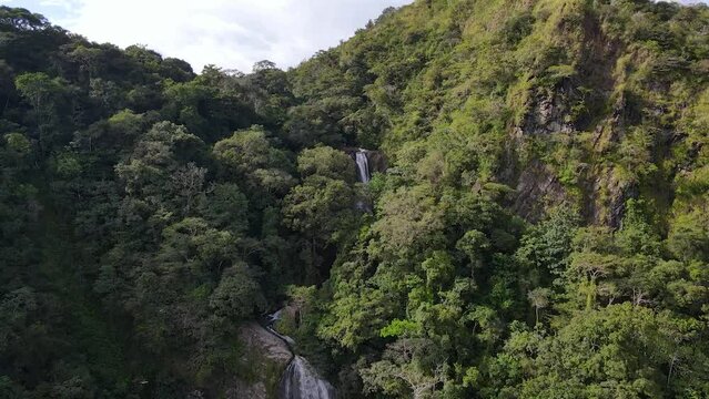 A waterfall from the Jurassic era in the Boruca territory, Costa Rica. Aerial drone shot, backward movement.
