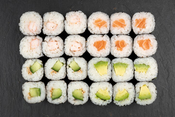 Above ground Japanese sushi food. Maki and rolls with tuna, salmon, shrimp, crab and avocado. Top view of various sushi, all you can eat menu. Rainbow sushi roll, uramaki, hosomaki and nigiri.